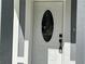 Close-up of the front door, highlighting the oval window at 3839 Se 132Nd Pl, Belleview, FL 34420