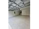 Spacious garage with overhead door and extra storage at 3839 Se 132Nd Pl, Belleview, FL 34420