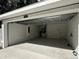 Open garage space with new epoxy floor coating and modern garage door at 3839 Se 132Nd Pl, Belleview, FL 34420
