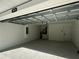 Two car garage with new epoxy floor coating and modern garage door at 3839 Se 132Nd Pl, Belleview, FL 34420