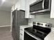 Modern kitchen with stainless steel appliances and white cabinetry at 3839 Se 132Nd Pl, Belleview, FL 34420