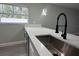 Kitchen sink with quartz countertop and black faucet at 3839 Se 132Nd Pl, Belleview, FL 34420