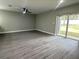 Spacious living area boasts modern gray flooring and a sliding glass door leading to the backyard at 3839 Se 132Nd Pl, Belleview, FL 34420