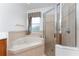 Primary bathroom with corner tub, shower, and dual vanity at 4010 Navigator Way, Kissimmee, FL 34746