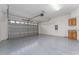 Attached garage with epoxy flooring and storage cabinets at 4010 Navigator Way, Kissimmee, FL 34746