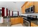 Modern kitchen with stainless steel appliances and granite countertops at 4010 Navigator Way, Kissimmee, FL 34746