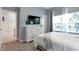 Bright bedroom with large windows, white dresser, and TV at 4349 Quote St, Kissimmee, FL 34746