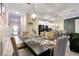 Elegant dining room set for six, with open concept to kitchen and living area at 4349 Quote St, Kissimmee, FL 34746