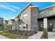 Modern two-story townhome with stone accents and landscaped front yard at 4349 Quote St, Kissimmee, FL 34746