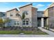 Modern two-story townhome with stone accents and landscaped front yard at 4349 Quote St, Kissimmee, FL 34746