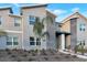 Modern two-story townhome with stone accents and landscaped front yard at 4349 Quote St, Kissimmee, FL 34746