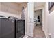 Convenient laundry room with washer, dryer, and shelving at 4349 Quote St, Kissimmee, FL 34746