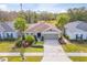 One story house with light brown siding, two-car garage, and manicured landscaping at 4483 Casablanca Ave, Kissimmee, FL 34746