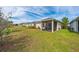 View of backyard with screened patio and neighboring homes at 4483 Casablanca Ave, Kissimmee, FL 34746