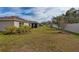 Landscaped backyard showcasing home's exterior and fence at 4483 Casablanca Ave, Kissimmee, FL 34746