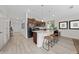 Modern kitchen with island, stainless steel appliances, and light wood cabinets at 4483 Casablanca Ave, Kissimmee, FL 34746