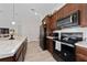 Modern kitchen with stainless steel appliances and light wood cabinets at 4483 Casablanca Ave, Kissimmee, FL 34746