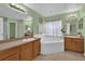 Bathroom with double vanity, garden tub, and shower at 4702 Ashurst St, Kissimmee, FL 34758
