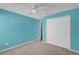 Light blue bedroom with ceiling fan and closet at 4702 Ashurst St, Kissimmee, FL 34758