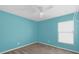 Light blue bedroom with ceiling fan and large closet at 4702 Ashurst St, Kissimmee, FL 34758