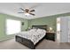 Spacious bedroom with king-size bed and ceiling fan at 4702 Ashurst St, Kissimmee, FL 34758