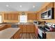 Spacious kitchen with light wood cabinets and stainless steel appliances at 4702 Ashurst St, Kissimmee, FL 34758