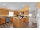 Open kitchen with island, wood cabinets, and stainless steel appliances at 4702 Ashurst St, Kissimmee, FL 34758