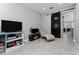 Bonus room with TV, chaise lounge, and barn door at 4806 Tribute Trl, Kissimmee, FL 34746