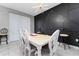 Dining room with white table and dark accent wall at 4806 Tribute Trl, Kissimmee, FL 34746