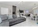 Open living and kitchen area with gray couch and kitchen island at 4806 Tribute Trl, Kissimmee, FL 34746