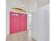 Bright entryway with pink double doors and white cabinets at 4878 Zion Dr, St Cloud, FL 34772