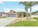 Single-story house with a three-car garage and landscaped yard at 4878 Zion Dr, St Cloud, FL 34772