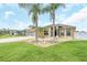Attractive single-story home with palm trees and well-manicured lawn at 4878 Zion Dr, St Cloud, FL 34772