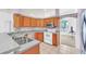 Kitchen boasts wood cabinets, granite countertops, and stainless steel appliances at 4878 Zion Dr, St Cloud, FL 34772