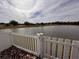 White picket fence and tranquil lake view from the backyard at 4878 Zion Dr, St Cloud, FL 34772