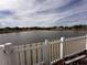 Scenic backyard view of a lake with white picket fence at 4878 Zion Dr, St Cloud, FL 34772