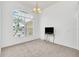 Living room with large window and neutral carpeting at 4878 Zion Dr, St Cloud, FL 34772
