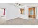 Bright living room with carpet flooring and a view into a sunroom at 4878 Zion Dr, St Cloud, FL 34772