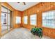 Sunroom with wood paneling, tile floor and large windows at 4878 Zion Dr, St Cloud, FL 34772