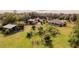 Aerial view of a home with several outbuildings and a lush garden at 4999 Disston Dr, St Cloud, FL 34771