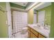 Simple bathroom with light green walls and white shower curtain at 4999 Disston Dr, St Cloud, FL 34771