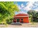 Red metal building with bamboo and trees at 4999 Disston Dr, St Cloud, FL 34771