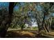 Mature oak trees with Spanish moss frame the home at 4999 Disston Dr, St Cloud, FL 34771