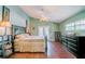 Main bedroom with wood floors, ceiling fan, and access to backyard at 4999 Disston Dr, St Cloud, FL 34771