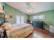 Main bedroom with wood floors, ceiling fan, and access to backyard at 4999 Disston Dr, St Cloud, FL 34771