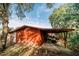 Rustic red storage shed with covered patio area at 4999 Disston Dr, St Cloud, FL 34771