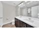 Modern bathroom with double vanity, large mirror, and tile flooring at 6530 Stoller Ave, Windermere, FL 34786