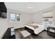 Bright bedroom with double bed, dark wood flooring, and window views at 6530 Stoller Ave, Windermere, FL 34786
