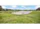 Peaceful community pond with walking path at 6530 Stoller Ave, Windermere, FL 34786