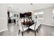 Spacious dining area with a dark wood table and white chairs, open to kitchen at 6530 Stoller Ave, Windermere, FL 34786